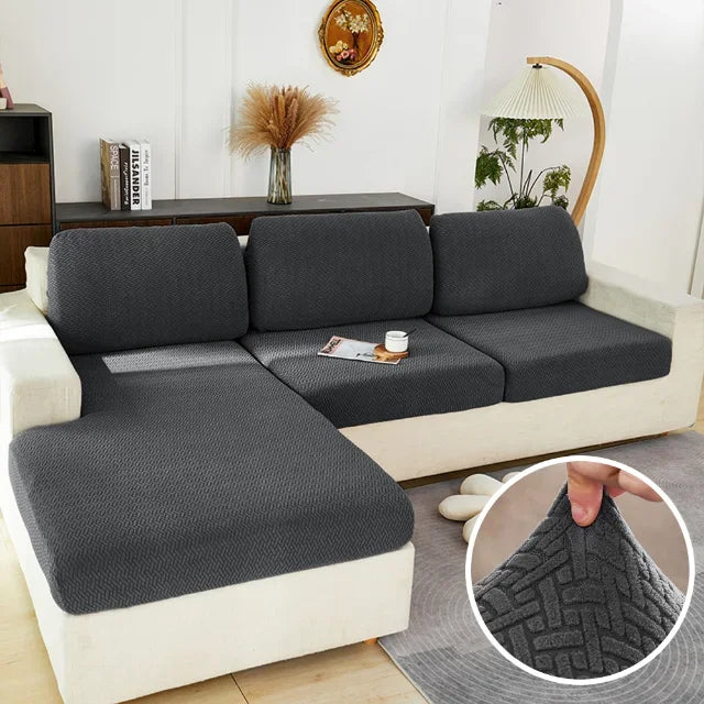 Protection canapé gris foncé vide sur canapé crème avec bulle coin droit zoomé montrant tissu 